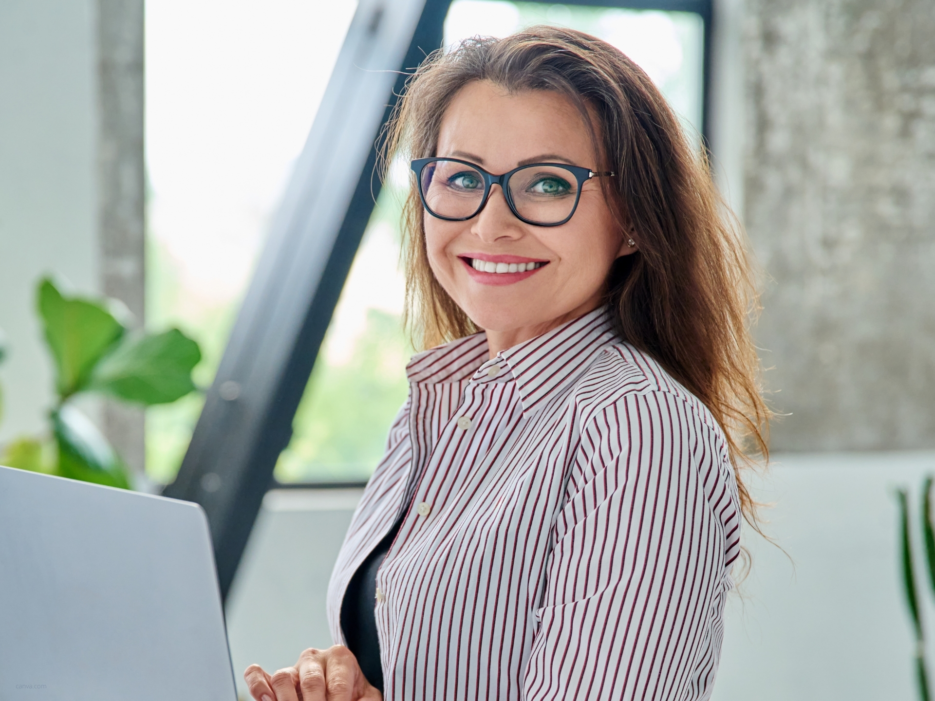 Frau aus dem Marketing lächelt im modernen Büro